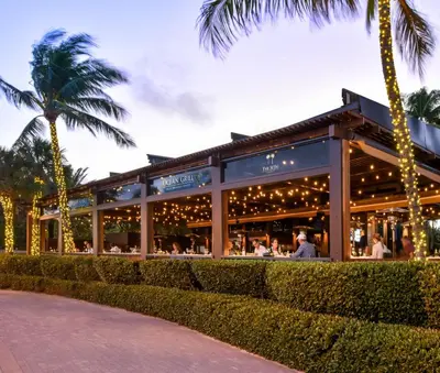 a restaurant with christmas lights and palm trees at The Setai, Miami Beach in Miami Beach