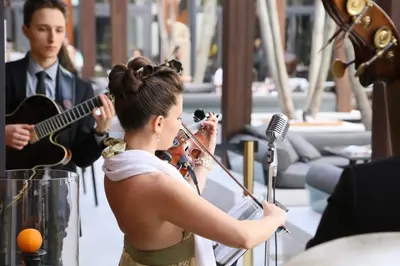 a woman playing a violin and a man playing music at The Setai, Miami Beach in Miami Beach