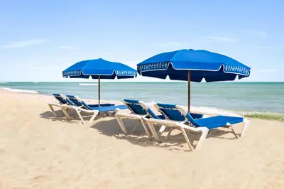 a group of chairs and umbrellas on a beach at Lexington by Hotel RL Miami Beach in Miami Beach