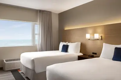 two beds in a hotel room with a window at Lexington by Hotel RL Miami Beach in Miami Beach