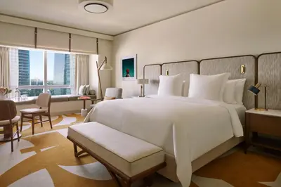 a bedroom with a large white bed and a large window at Four Seasons Hotel Miami in Miami