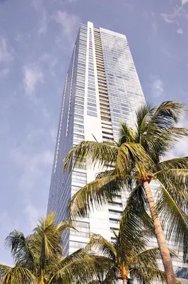 a tall building with palm trees in front of it at Four Seasons Hotel Miami in Miami