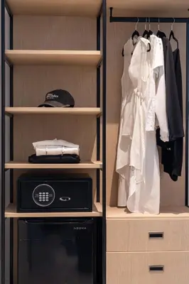 a walk in closet with a microwave and clothes at Nassau Suite South Beach, an All Suite Hotel in Miami Beach