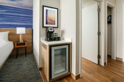 a hotel room with a television and a bed at Courtyard by Marriott Oceanside Fort Lauderdale Beach in Fort Lauderdale