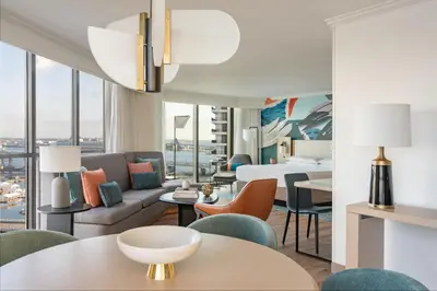 a living room with a couch and tables and chairs at Miami Marriott Biscayne Bay in Miami