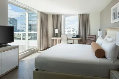 a hotel room with a large bed and a television at Marriott Stanton South Beach in Miami Beach