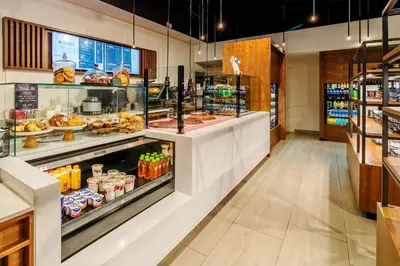 a bakery with a display case filled with food at Hyatt Regency Miami in Miami