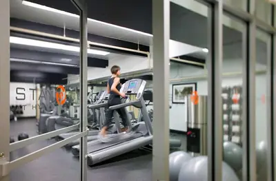 a woman running on a treadmill in a gym at Hyatt Regency Miami in Miami