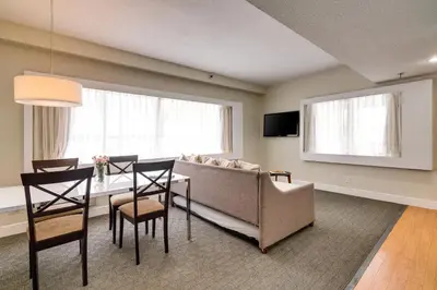 a living room with a couch and a table at Crest Hotel Suites in Miami Beach