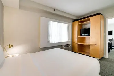 a hotel room with a bed and a window at Crest Hotel Suites in Miami Beach