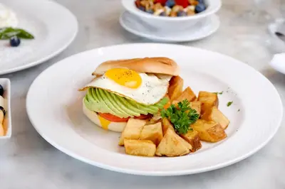 a plate of food with an egg and chips at Liberty Park Hotel South Beach in Miami Beach