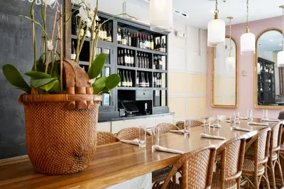 a long table in a restaurant with chairs at Liberty Park Hotel South Beach in Miami Beach