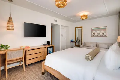 a bedroom with a bed and a tv on the wall at Liberty Park Hotel South Beach in Miami Beach