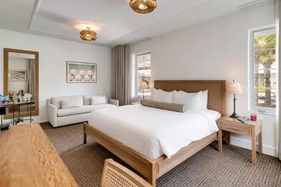 a bedroom with a large white bed and a couch at Liberty Park Hotel South Beach in Miami Beach