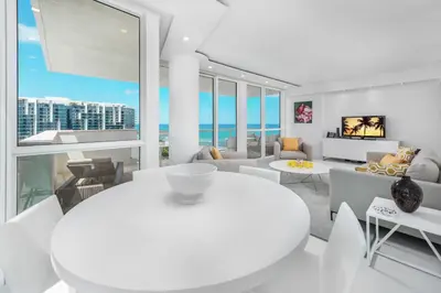 a white living room with a view of the ocean at 4B Super Premium Private Condo at the Setai in Miami Beach