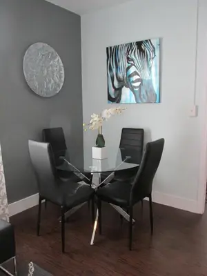 a dining room with a glass table and chairs at Ocean Blue in Miami Beach