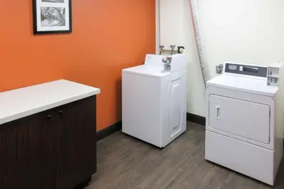 a laundry room with a washing machine and a washer at Sleep Inn & Suites Ft Lauderdale International Airport in Dania Beach