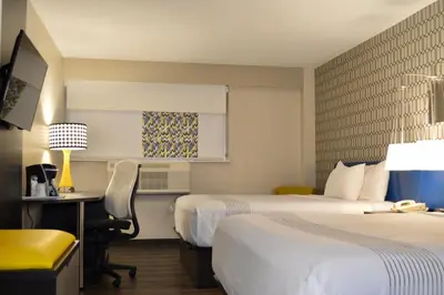 a hotel room with two beds and a desk at Best Western Plus Ft Lauderdale Hollywood Airport Hotel in Hollywood