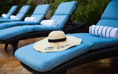 a hat is sitting on top of blue chairs at Sun Tower Hotel & Suites on the Beach in Fort Lauderdale