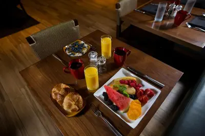 a table with a plate of fruit and orange juice at InterContinental Miami by IHG in Miami