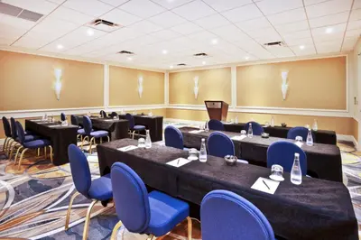 a conference room with tables and chairs and a podium at InterContinental Miami by IHG in Miami