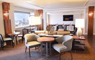 a hotel room with a lobby with a table and chairs at InterContinental Miami by IHG in Miami