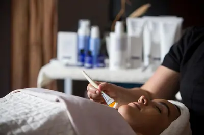 a woman laying in a hospital bed holding a thermometer at InterContinental Miami by IHG in Miami