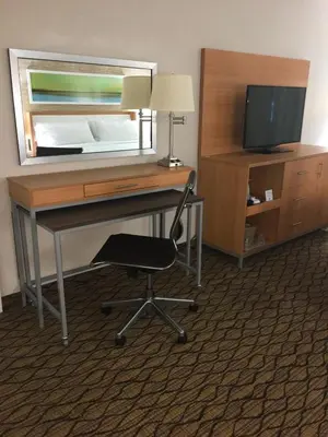 a desk with a chair and a television in a hotel room at Holiday Inn Miami Beach-Oceanfront by IHG in Miami Beach