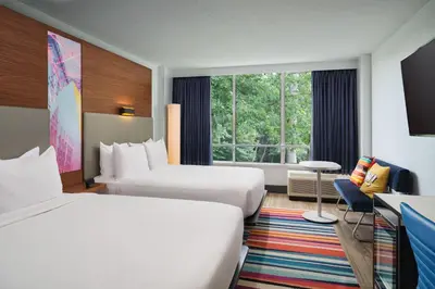 a hotel room with two beds and a window at Aloft Miami Dadeland in Kendall
