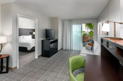 a hotel room with a bed and a television at Staybridge Suites Miami Doral Area by IHG in Miami