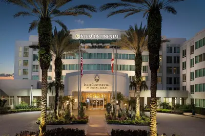 a building with palm trees in front of it at InterContinental At Doral Miami by IHG in Miami