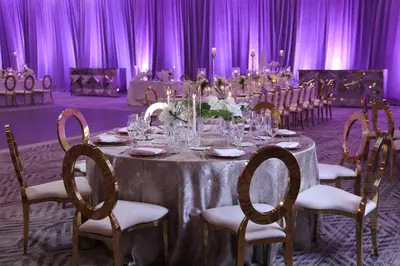 a table in a room with chairs and purple curtains at InterContinental At Doral Miami by IHG in Miami