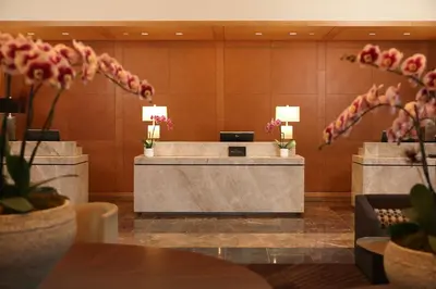 a reception desk in a hotel lobby with flowers at InterContinental At Doral Miami by IHG in Miami