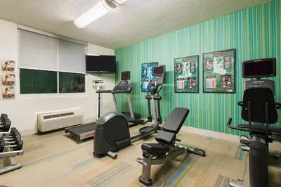 a gym with several exercise equipment in a room at Holiday Inn Express Miami Airport Doral Area by IHG in Miami