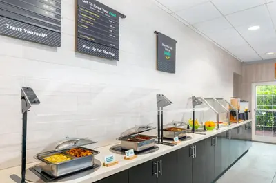 a buffet line with trays of food at Holiday Inn Miami-Doral Area by IHG in Miami