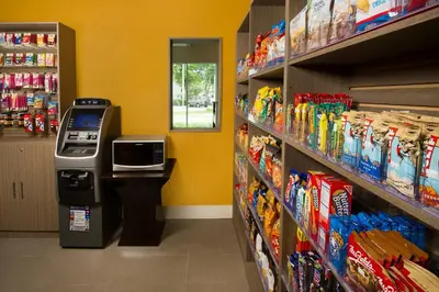 a grocery store aisle with a cash register in a store at Holiday Inn Miami-Doral Area by IHG in Miami