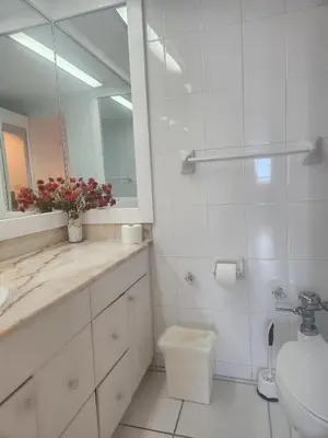 a bathroom with a sink and a mirror and a toilet at L&D Vacations Rentals in Miami Beach