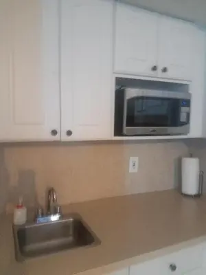 a kitchen with a sink and a microwave at L&D Vacations Rentals in Miami Beach