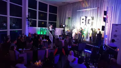a group of people on a stage with a crowd at L&D Vacations Rentals in Miami Beach