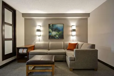 a living room with a couch and a chair at Hyatt Place Miami Airport-West/Doral in Miami