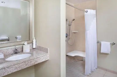 a bathroom with a sink and a shower at Hilton Garden Inn Miami Airport West in Miami