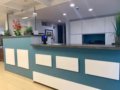a lobby with a counter in a hospital with plants at The Hollywood Gateway Inn in Hollywood