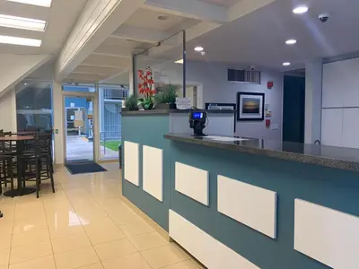 a lobby with a bar with a table and chairs at The Hollywood Gateway Inn in Hollywood