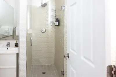 a shower with a glass door in a bathroom at Riviere South Beach Hotel in Miami Beach