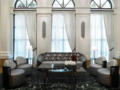 a living room with a couch and a table at Acqualina Resort and Residences in Miami Beach