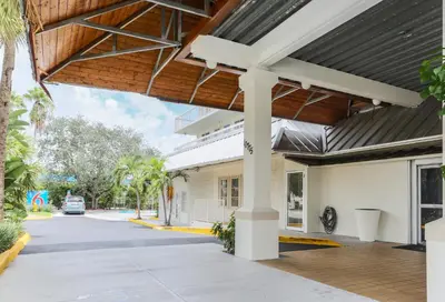 a view of the front of a building with awning at Motel 6-Cutler Bay, FL in Cutler Bay