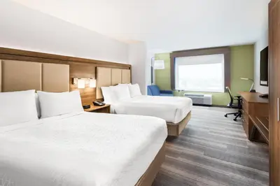 a hotel room with two beds and a television at Holiday Inn Express Ft Lauderdale Cruise-Airport by IHG in Fort Lauderdale