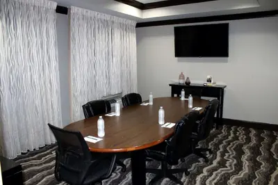 a conference room with a large wooden table and chairs at Sonesta ES Suites Fort Lauderdale Plantation in Plantation