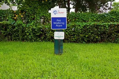 a parking sign in the grass in the yard at Candlewood Suites Fort Lauderdale Airport-Cruise by IHG in Fort Lauderdale
