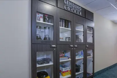 a cabinet with glass doors in a room at Candlewood Suites Fort Lauderdale Airport-Cruise by IHG in Fort Lauderdale